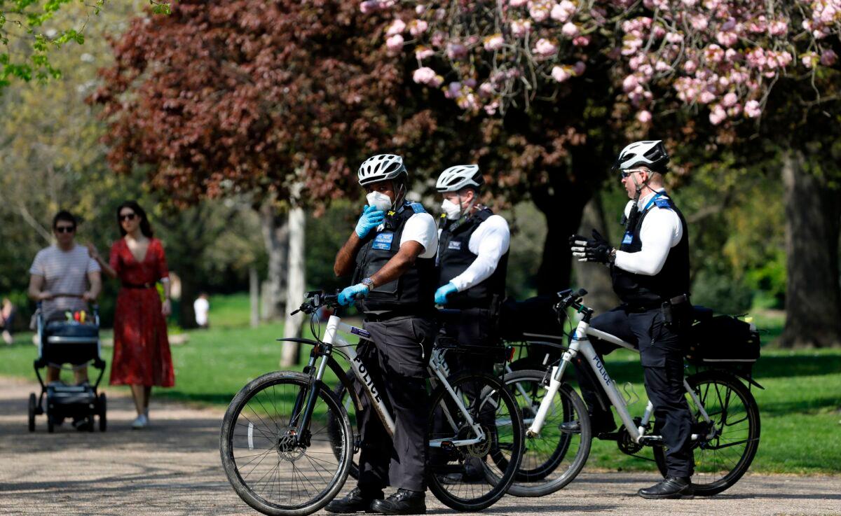 Officers of the Metropolitan Police patrol in Victoria Park, east London, on April 11, 2020. (Tolga Akmen/AFP via Getty Images)