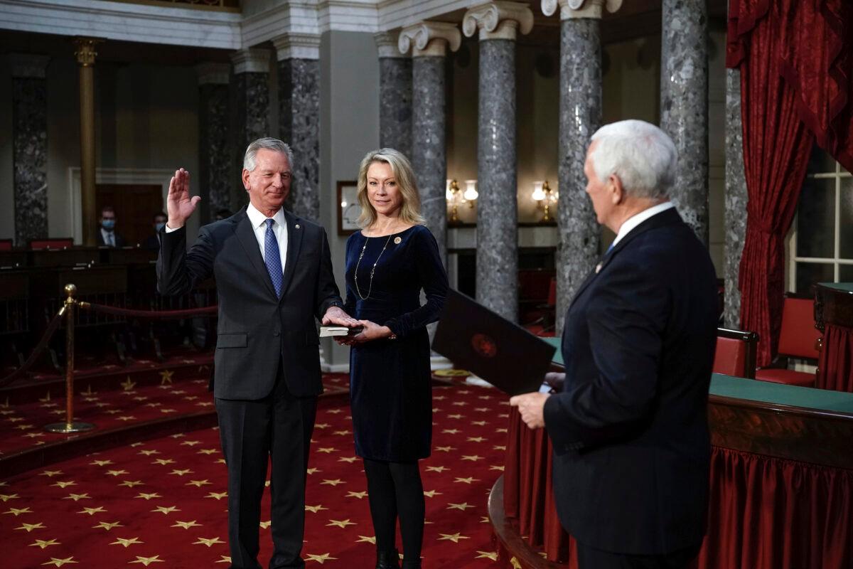 Vice President Mike Pence administers the Senate oath of office to Sen. Tommy Tuberville (R-Ala), the former Auburn University football coach, as his wife, Suzanne Tuberville, holds the Bible during a mock swearing-in ceremony in the Old Senate Chamber on Capitol Hill in Washington, on Jan. 3, 2021. (J. Scott Applewhite-Pool/Getty Images)