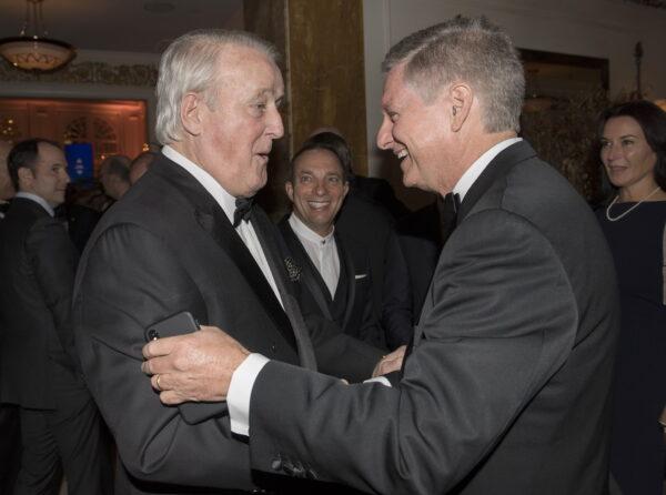 Former prime mininster Brian Mulroney (L) greets Paul Desmarais Jr., then chairman and co-chief executive officer of Power Corporation of Canada, during an event in Mulroney's honour in Montreal on May 9, 2019. (The Canadian press/Graham Hughes)