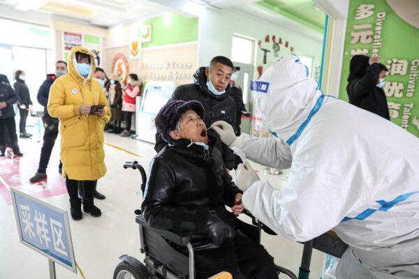 A woman is tested for COVID-19 in Shenyang, China on Jan. 1, 2021. (STR/AFP via Getty Images)