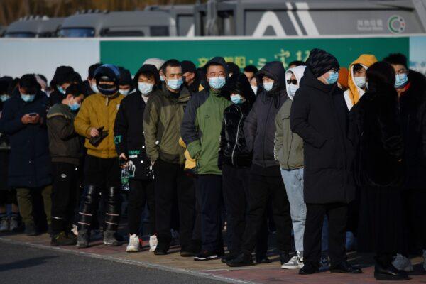 People wait to board shuttle buses to a COVID-19 vaccine center in Beijing, China on Jan. 4, 2021. (GREG BAKER/AFP via Getty Images)