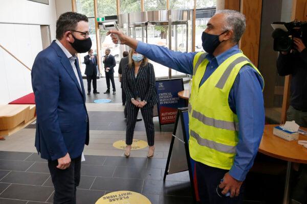 Victorian Premier Daniel Andrews has his temperature checked at The Doherty Institute in Melbourne, Australia on Nov. 13, 2020. (Darrian Traynor/Getty Images)