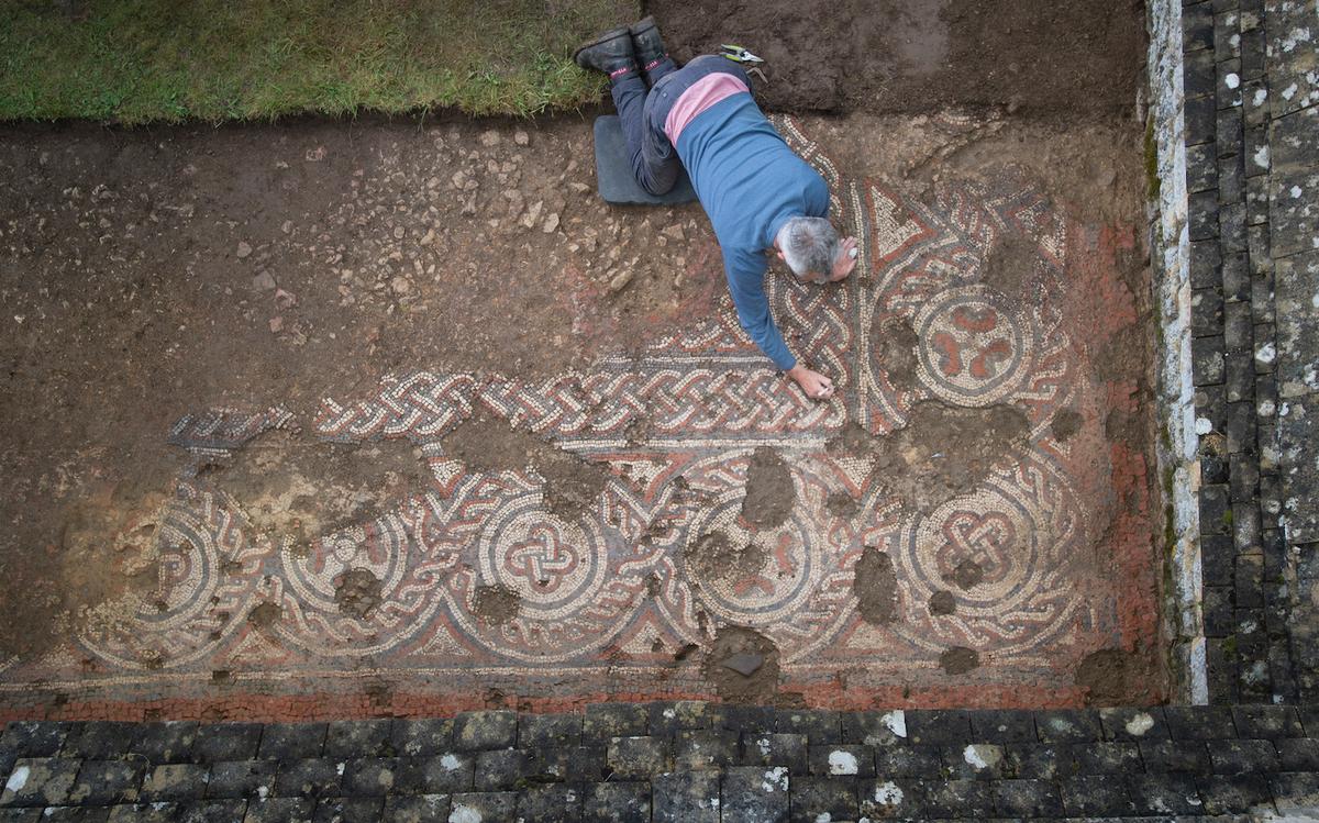 Archeologist Martin Papworth with the mosaic at Chedworth Roman Villa, England (Courtesy of Stephen Haywood/<a href="https://www.nationaltrust.org.uk/">National Trust</a>)