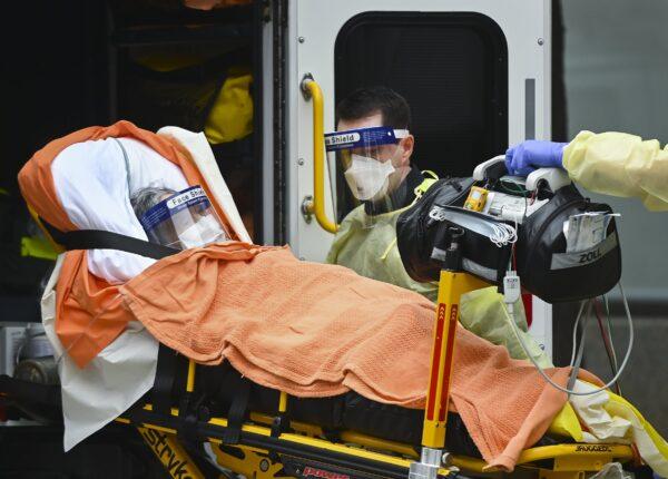 Paramedics take away an elderly patient at the Tendercare Living Centre, long-term-care facility during the COVID-19 pandemic in Scarborough, Ont., Canada, on Dec. 23, 2020. (Nathan Denette/The Canadian Press)