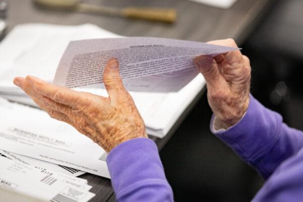 A volunteer sorts recall mail to oust California Governor Gavin Newsom at Capital Campaigns Inc. in Newport Beach, Calif., on Jan 4, 2021. (John Fredricks/The Epoch Times)