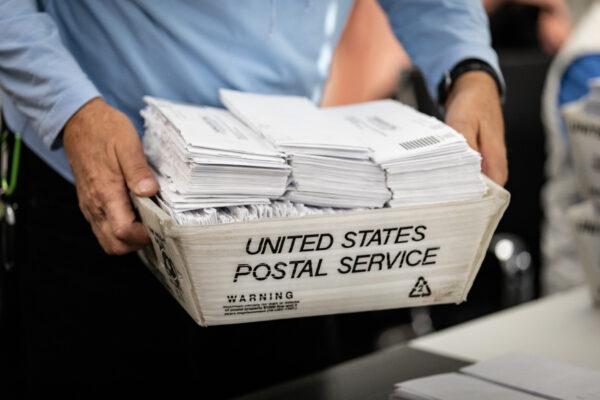 A volunteer sorts recall mail to oust California Governor Gavin Newsom at Capital Campaigns Inc. in Newport Beach, Calif., on Jan 4, 2021. (John Fredricks/The Epoch Times)