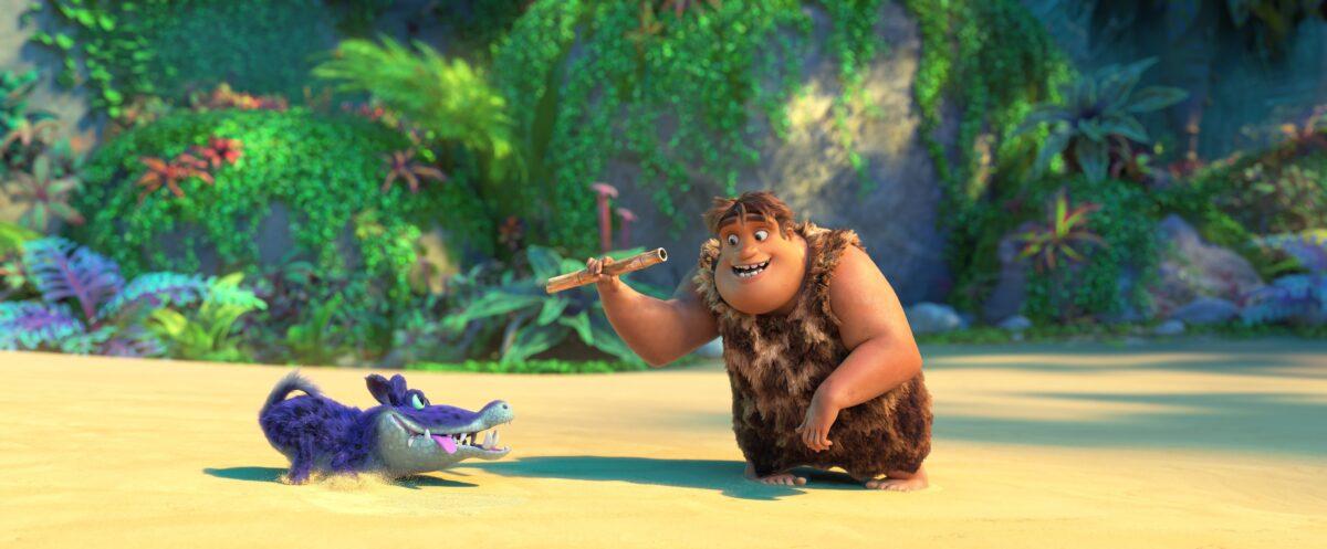 Thunk Crood (voiced by Clark Duke) playing “fetch” with his croc-dog, Douglas, in "The Croods: A New Age." (Universal Pictures)