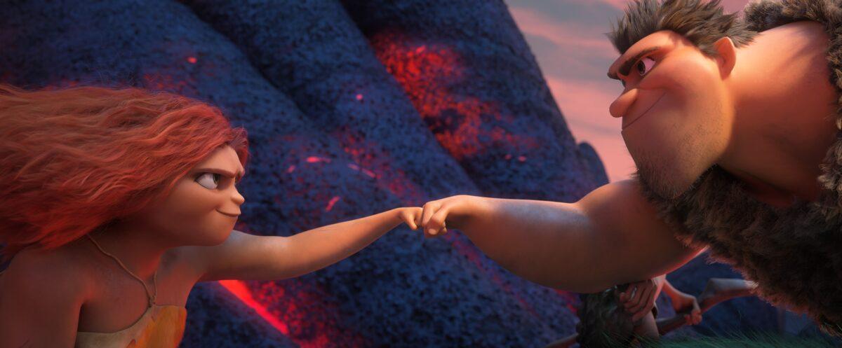 Daughter Eep Crood (voiced by Emma Stone) and dad Grug (Nicholas Cage) successfully navigating a path over hot lava, in "The Croods: A New Age." (Universal Pictures)