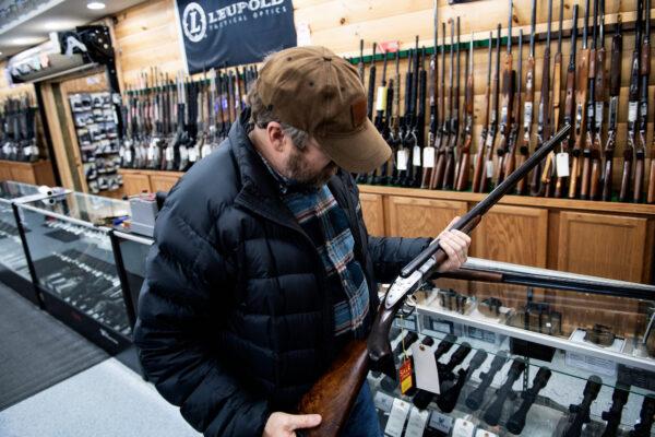 A customer looks at an antique shotgun at a gun shop in Ottawa, Ohio, on Jan. 23, 2020. (Brendan Smialowski/AFP via Getty Images)