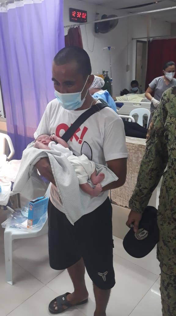 Motorcyclist Junrell Fuentes Revilla holding the newborn baby boy he saved from a dumpsite. (Courtesy of <a href="https://www.facebook.com/sibonga.wcpd">Sibonga Police Department's Women and Children Protection Desk</a> via <a href="https://www.facebook.com/hopeforstrayscebu/">Hope for Strays</a>)