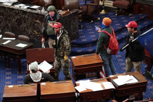 A group of protesters enter the Senate Chamber in Washington on Jan. 6, 2021. (Win McNamee/Getty Images)