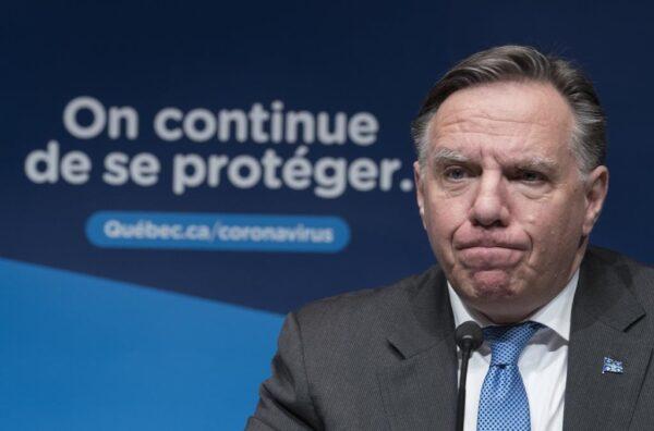 Quebec Premier Francois Legault listens to a question during a news conference in Montreal on Dec. 22, 2020. (Paul Chiasson/The Canadian Press)