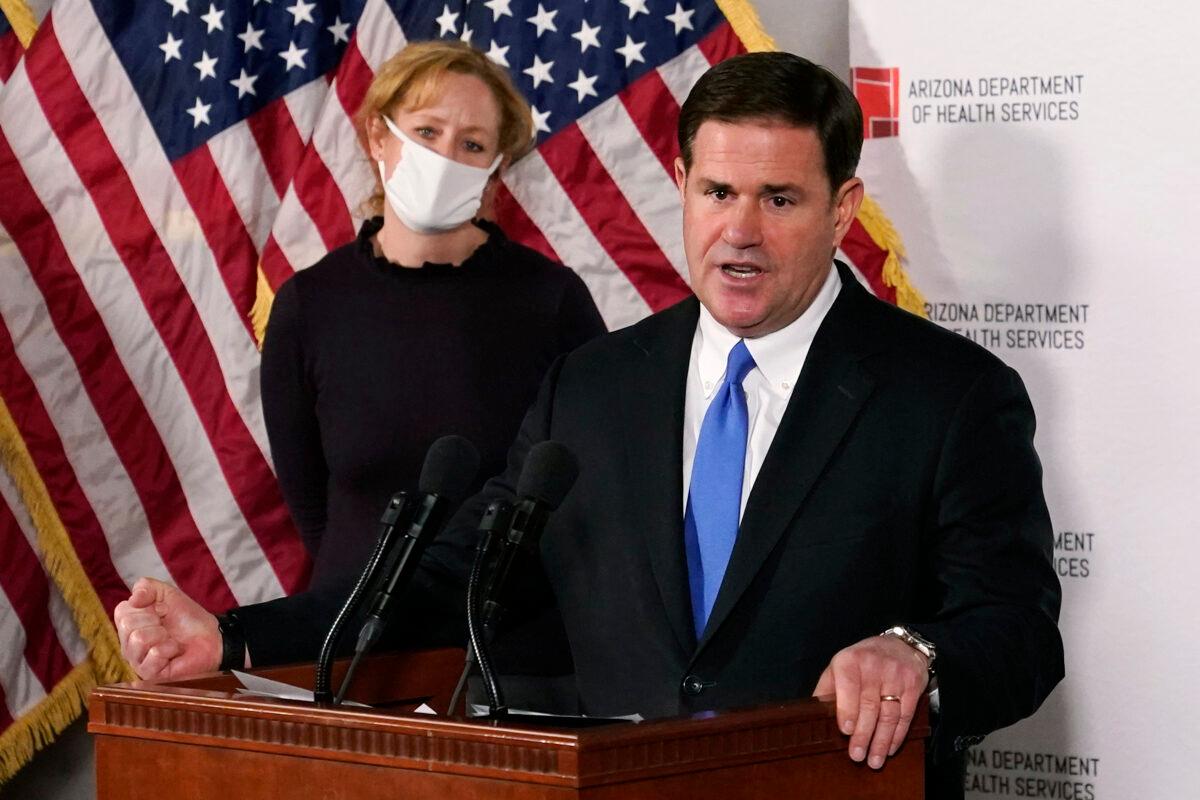 Arizona Gov. Doug Ducey answers a question about the arrival of a COVID-19 vaccine in Arizona, while Arizona Department of Health Services Director Dr. Cara Christ listens in Phoenix, Ariz. on Dec. 2, 2020. (Ross D. Franklin, Pool/AP Photo, File)