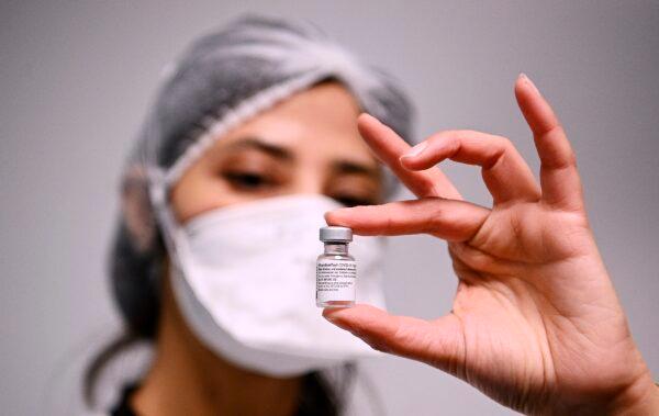 A health worker displays a dose of the Pfizer-BioNTech COVID-19 vaccine at Robert Ballanger hospital in Aulnay-sous-Bois, north of Paris on Jan. 6, 2021. (Christophe Archambault/Pool Photo via AP)