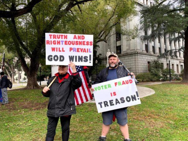 Rally attendees hold signs at the California State Capitol in Sacramento, Calif., on Jan. 6, 2021. (Nancy Han/NTD)