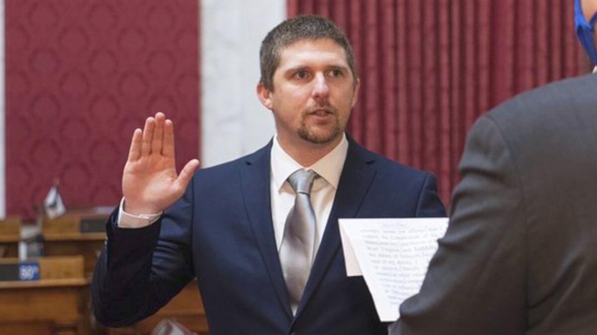 West Virginia House of Delegates member Derrick Evans (L), is given the oath of office in the House chamber at the state Capitol in Charleston, W.V., on Dec. 14, 2020. (Perry Bennett/West Virginia Legislature via AP)
