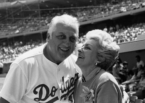 Jo Lasorda, wife of Los Angeles Dodgers' manager Tommy Lasorda, leans up to give him a good luck kiss on the start of his 35th season with the Dodger organization, in Los Angeles on April 4, 1984. (Lennox Mclendon/AP Photo File)