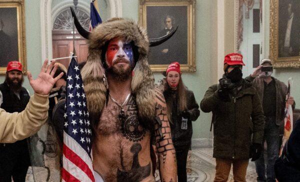 Jake Angeli (C) entered the Capitol building during a protest with his painted face and horned hat in Washington, on Jan. 6, 2021. (Saul Loeb/AFP via Getty Images)