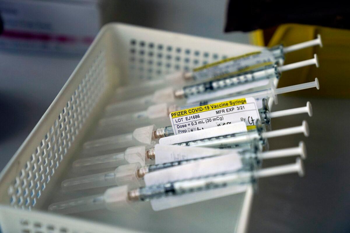 Syringes containing the Pfizer-BioNTech COVID-19 vaccine sit in a tray in a vaccination room at St. Joseph Hospital in Orange, Calif., on Jan. 7, 2021. (Jae C. Hong/AP Photo)