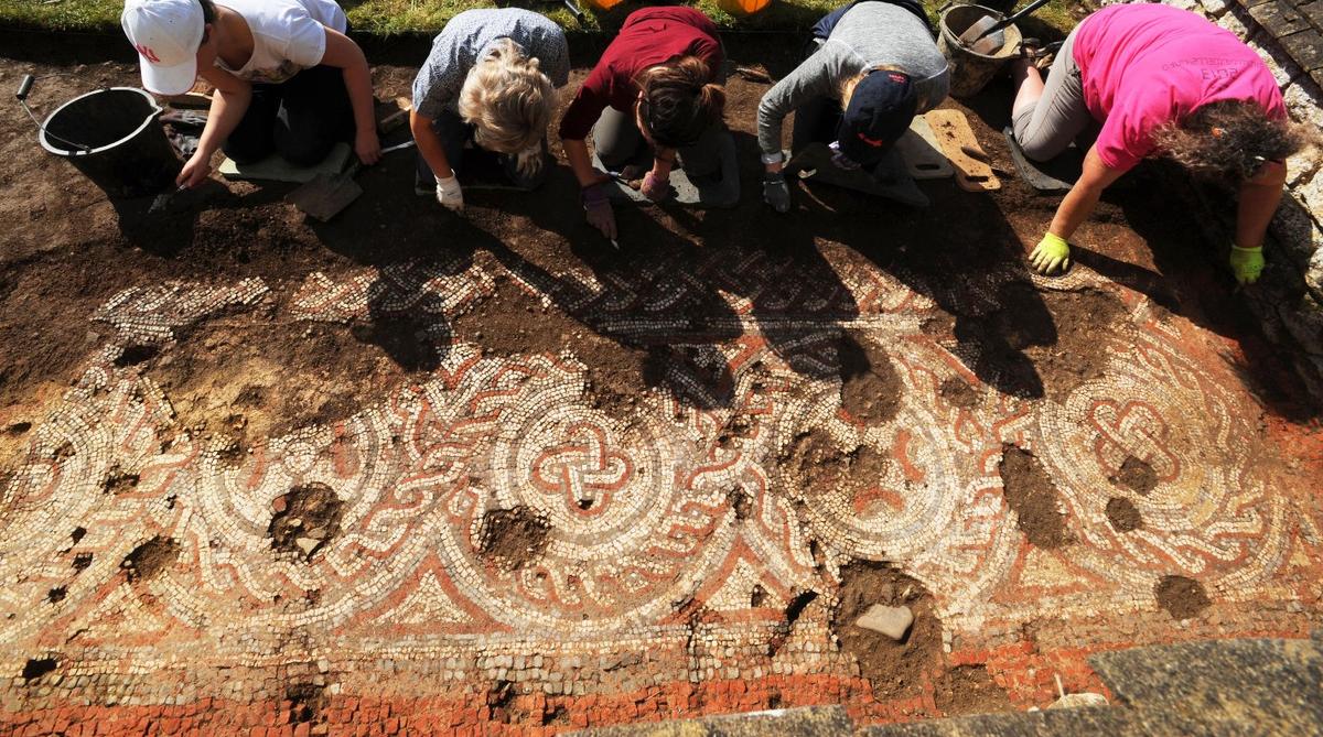 A group of volunteers uncovering the mosaic at Chedworth Roman Villa, England (Courtesy of Barry Batchelor/<a href="https://www.nationaltrust.org.uk/">National Trust</a>)