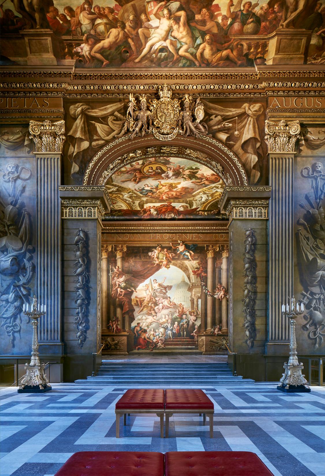 The proscenium arch connects the lower and upper Painted Hall. On the arch’s ceiling are the allegorical signs of the zodiac representing the constellations the seamen navigated by. (Old Royal Naval College)