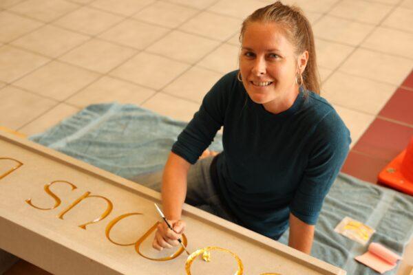 Alumna Mandy Hain designed the artwork for the ceiling of the chapel’s crossing tower, in addition to providing the gold-leaf lettering for the Latin inscription above the front doors of the chapel. (Christendom College)