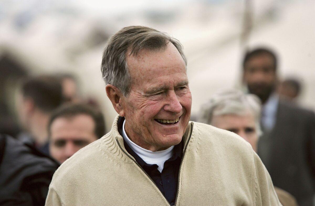 Former U.S. President George Bush visits a tent camp for earthquake survivors on the outskirts of Islamabad on Jan. 17, 2006. (John Moore/Getty Images)