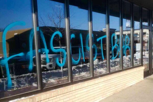 Graffiti along the front windows of Alibi Drinkery in the Minneapolis metro area, Minn., on Jan. 3, 2021. (Courtesy of Lisa Monet Zarza)