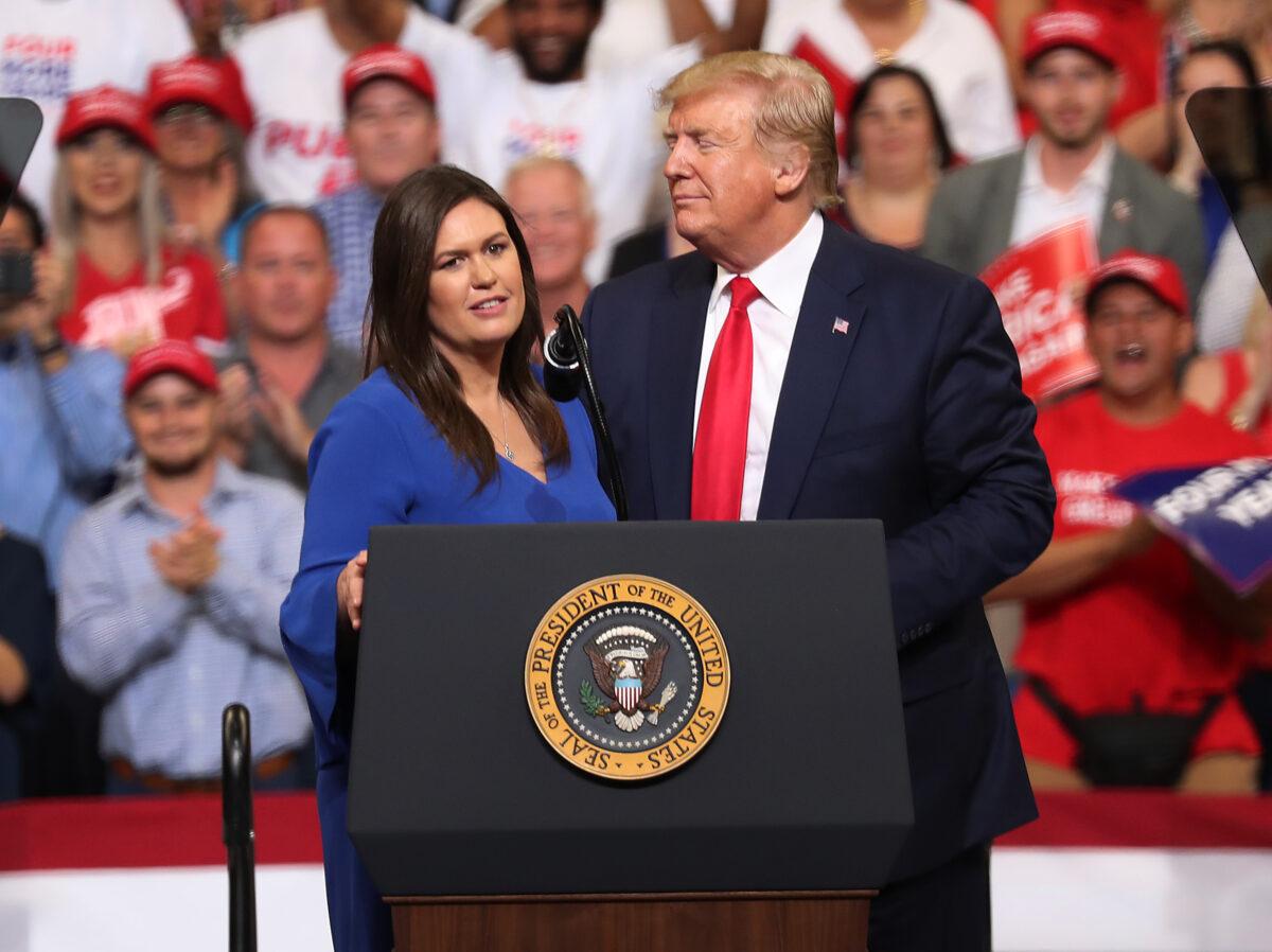 President Donald Trump stands with Sarah Huckabee Sanders during a rally in Orlando, Fla., on June 18, 2019. (Photo by Joe Raedle/Getty Images)