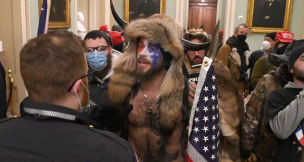 Jake Angeli (C) inside the U.S. Capitol building during a protest with his painted face and horned hat in Washington, D.C., on Jan. 6, 2021. (Saul Loeb/AFP via Getty Images)