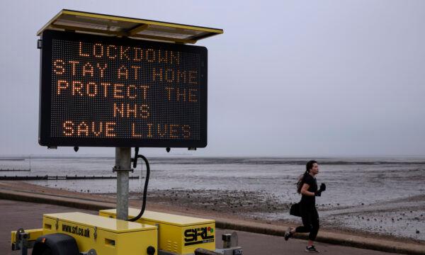A sign asking people to stay at home stands on the seafront in Southend, England on Jan. 8, 2021. (Dan Kitwood/Getty Images)