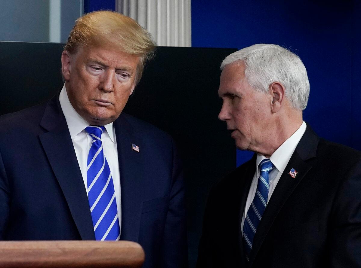 President Donald Trump and Vice President Mike Pence confer during a briefing in Washington on April 23, 2020. (Drew Angerer/Getty Images)