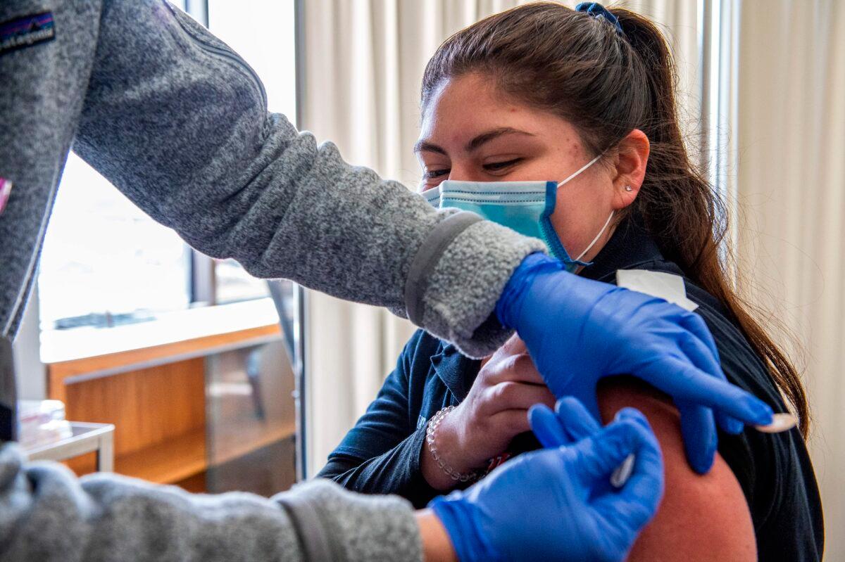Nurse Patti Ward inoculates EMT Jazmin Murillo with the Moderna COVID-19 vaccine at UMass Memorial Hospital in Marlborough, Mass., on Jan. 12, 2021. (Joseph Prezioso/AFP via Getty Images)