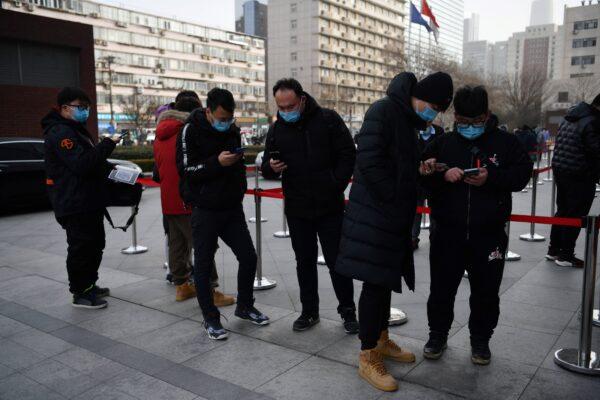 People line up outside a hospital to get COVID-19 tests in Beijing, on Jan. 13, 2021. (GREG BAKER/AFP via Getty Images)