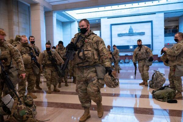 Hundreds of National Guard troops hold inside the Capitol Visitor's Center to reinforce security at the Capitol in Washington on Jan. 13, 2021. (J. Scott Applewhite/AP Photo)