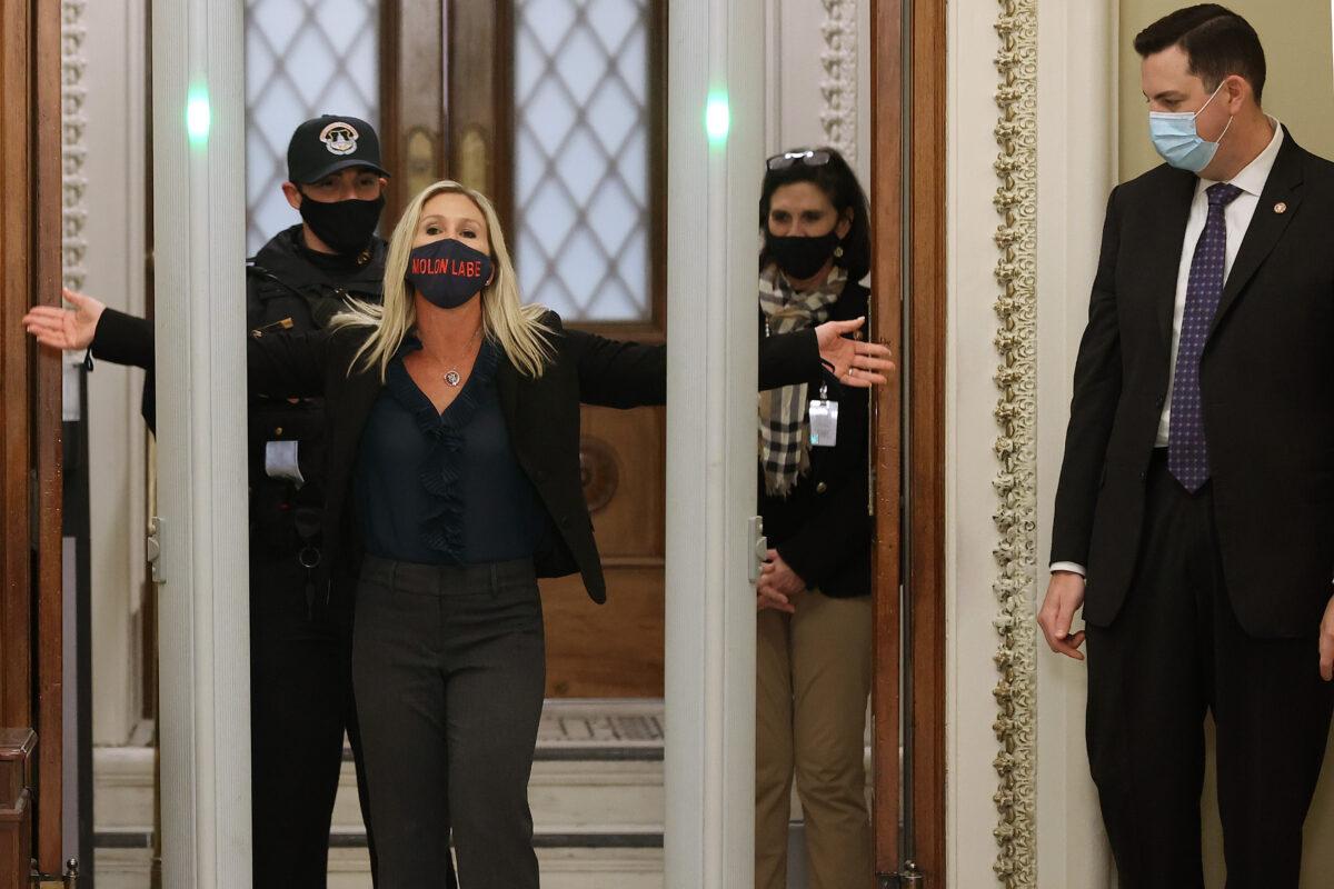 Rep. Marjorie Taylor Greene (R-GA) is searched by U.S. Capitol Police after setting off the metal detector outside the doors to the House of Representatives' Chamber in Washington on Jan. 12, 2021. (Chip Somodevilla/Getty Images)