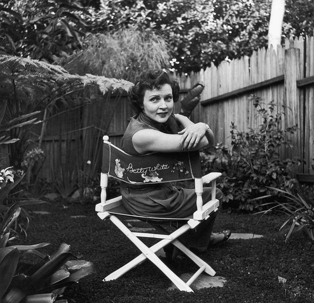 Betty White sits in a canvas chair with her name embellished on the back, circa 1956 (Hulton Archive/Getty Images)
