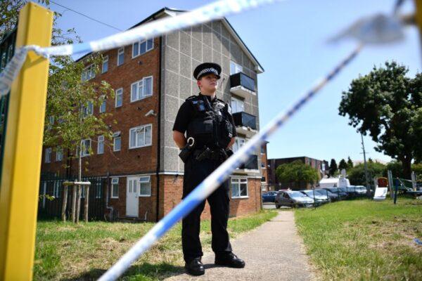 A police officer stands guard outside a cordoned off block of flats where the suspect of a multiple stabbing incident lived in Reading, west of London, on June 23, 2020. (Ben Stansall/AFP via Getty Images)