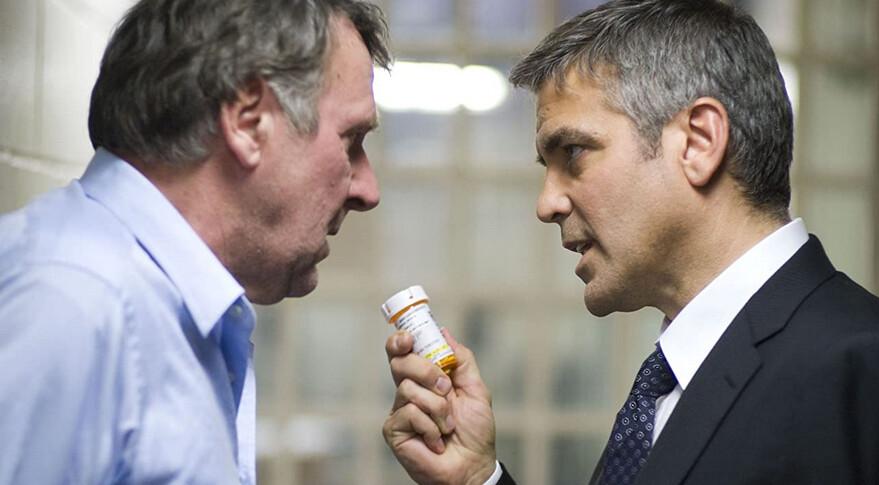 Arthur Edens (Tom Wilkinson, L) and Michael Clayton (George Clooney) argue about the state of Arthur's mental health, in "Michael Clayton." (Warner Bros.)