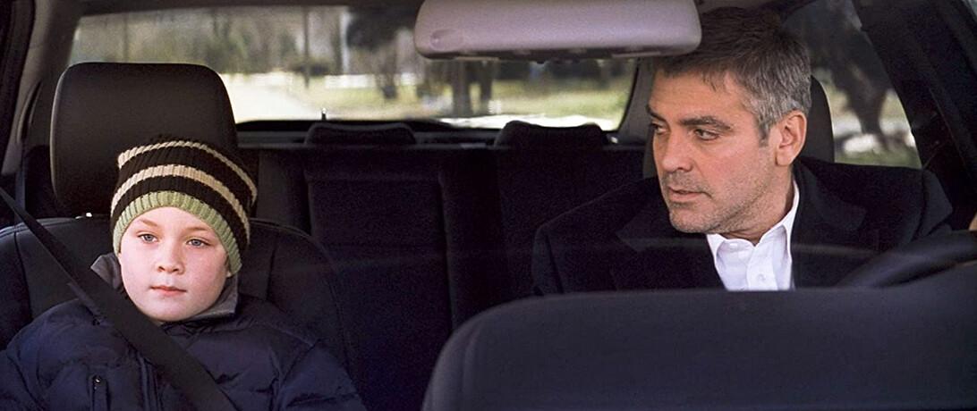 Henry Clayton (Austin Williams, L) and dad Michael Clayton (George Clooney) have a heart-to-heart, in "Michael Clayton." (Warner Bros.)