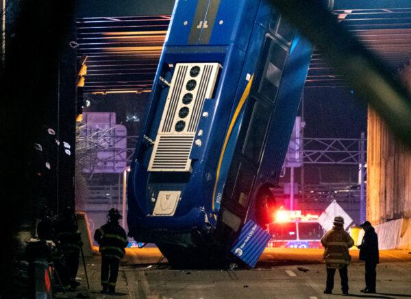 A bus in New York City which careened off a road in the Bronx neighborhood of New York is left dangling from an overpass, on Jan. 15, 2021. (Craig Ruttle/AP Photo)