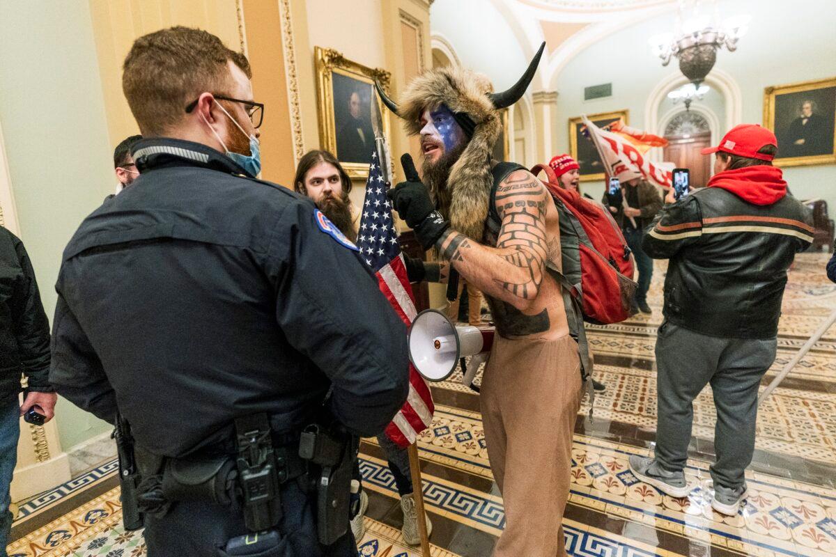 Protesters speak to U.S. Capitol Police officers outside the Senate Chamber inside the Capitol in Washington on Jan. 6, 2021. (Manuel Balce Ceneta/AP Photo)