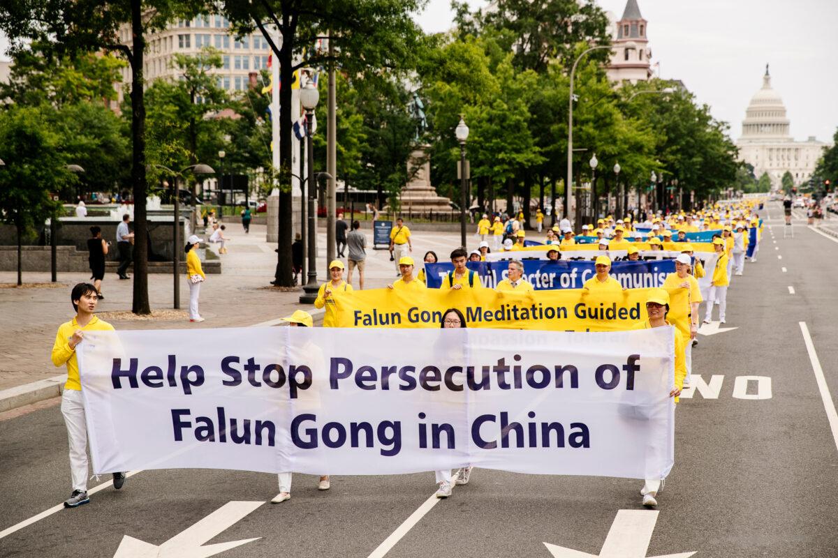 Falun Gong practitioners take part in a grand march calling for an end to the persecution of Falun Gong in China, in Washington on June 20, 2018. (Edward Dye/The Epoch Times)