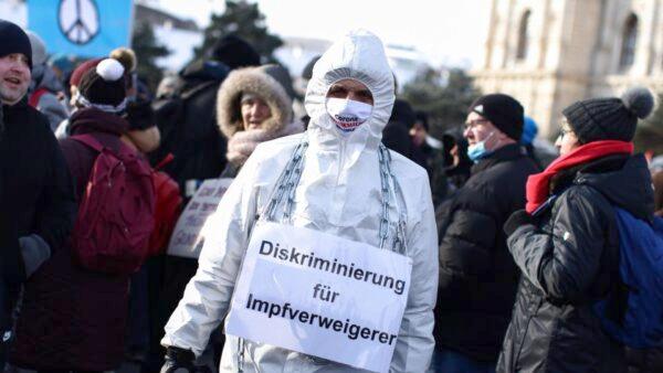 A protestor wears a sign reading "discrimination for vaccination refusers" during a demonstration against COVID-19 measures and their economic consequences in Vienna, Austria on Jan. 16, 2021. (Lisi Niesner/Reuters)