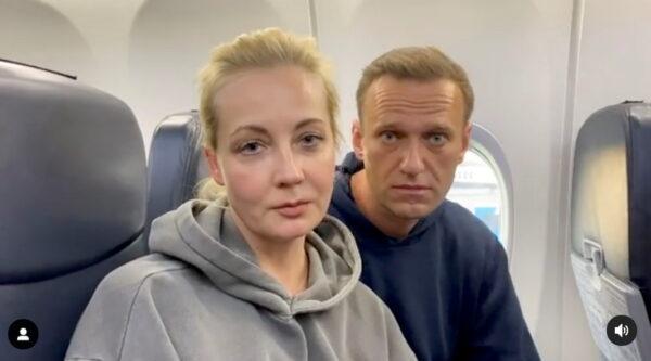 Russian opposition leader Alexei Navalny and his wife Yulia Navalnaya are seen on board a plane before the departure for the Russian capital Moscow at an airport in Berlin on Jan. 17, 2021. (Maria Vasilyeva/Reuters)