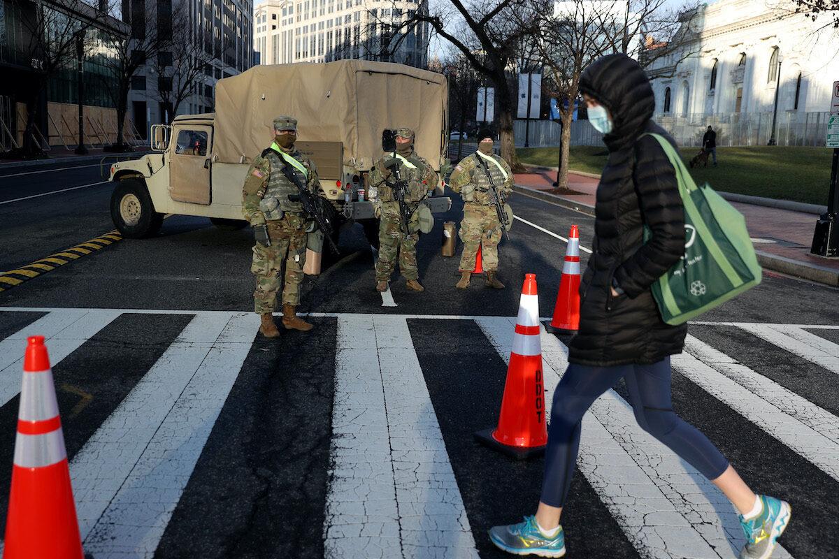 A person crosses the street at a roadblock guarded by Pennsylvania 112th Infantry Regiment National Guard in Washington on Jan. 16, 2021. (Joe Raedle/Getty Images)
