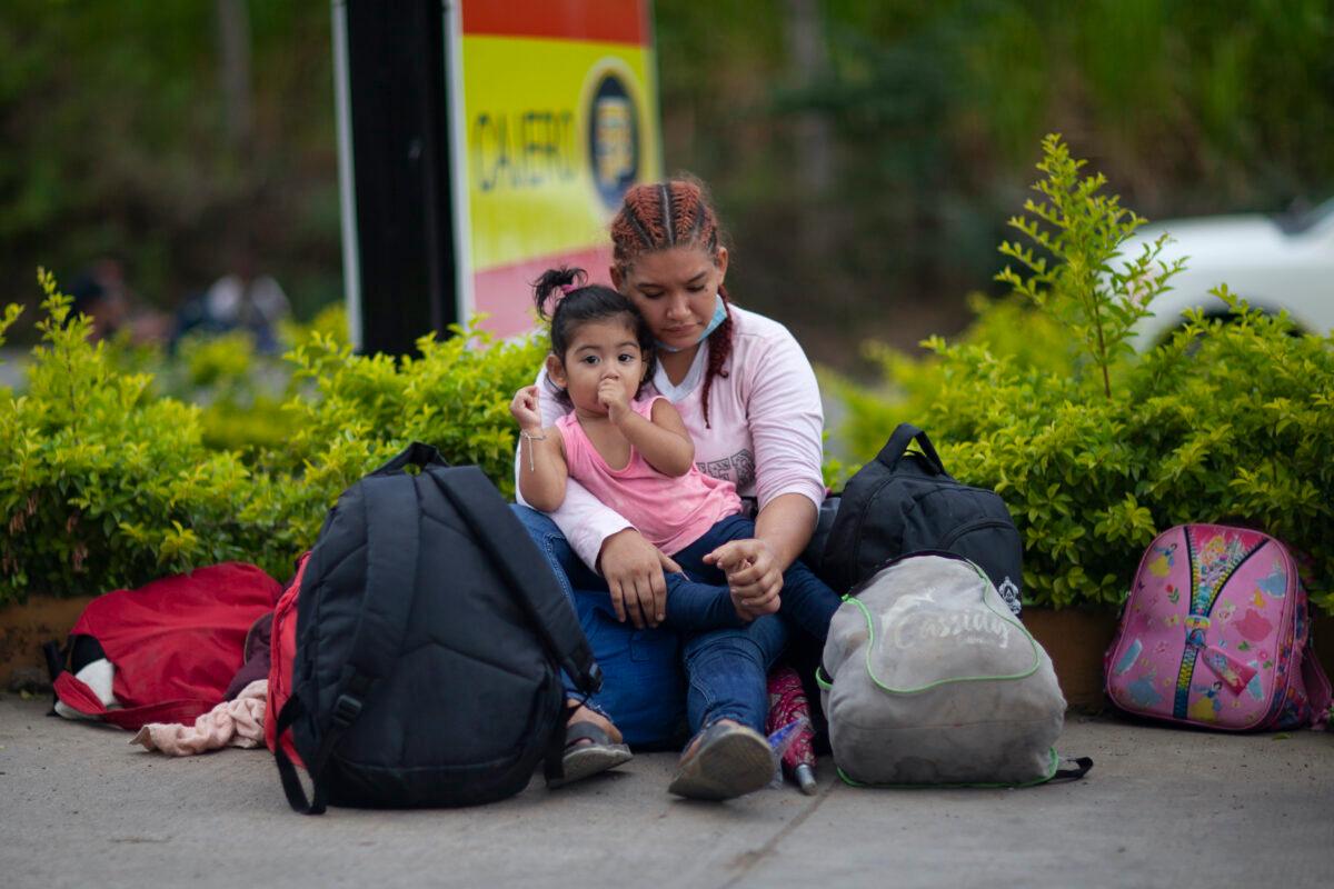 Migrants hoping to reach the distant U.S. border rest on the side of a highway, in Jocotan, Guatemala, on Jan. 16, 2021. (Sandra Sebastian/AP Photo)