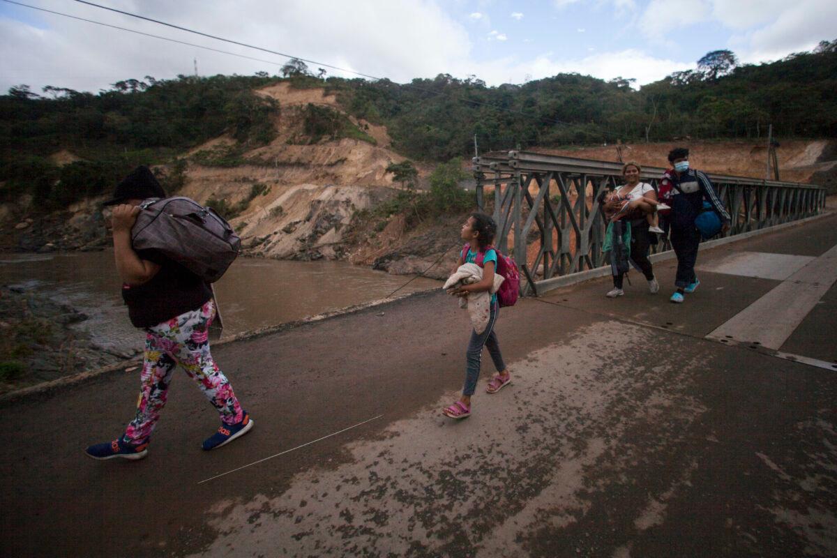 Migrants hoping to reach the distant U.S. border walk along a highway, in Jocotan, Guatemala, on Jan. 16, 2021. (Sandra Sebastian/AP Photo)