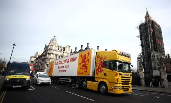 A lorry drives during a protest against post-Brexit bureaucracy that hinders exports to the European Union, at the Parliament Square in London, on Jan. 18, 2021. (Hannah McKay/Reuters)