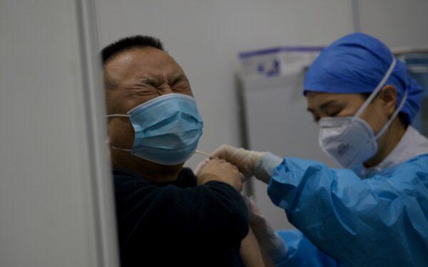 A medical worker inoculates a man with a COVID-19 vaccine at the Chaoyang Museum of Urban Planning in Beijing, China on Jan. 15, 2021. (NOEL CELIS/AFP via Getty Images)